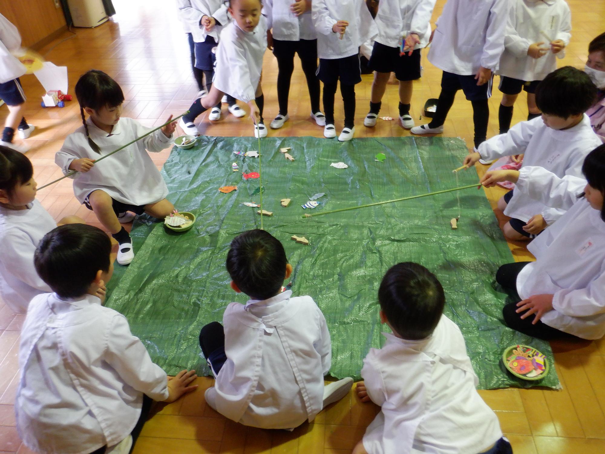 子どもたちがおもちゃの魚釣りで遊んでいる様子