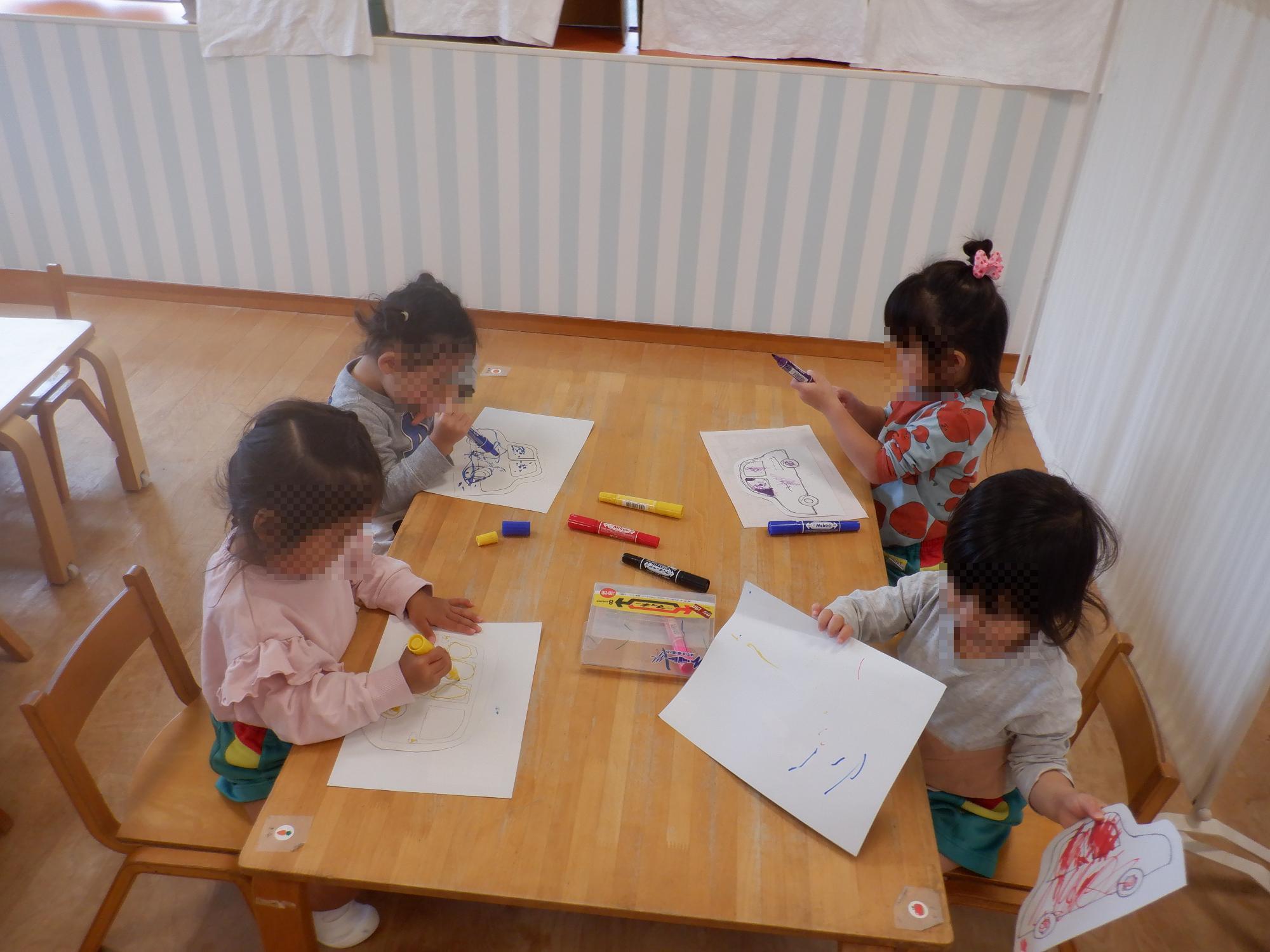 子ども達が厚紙自動車を製作している様子です