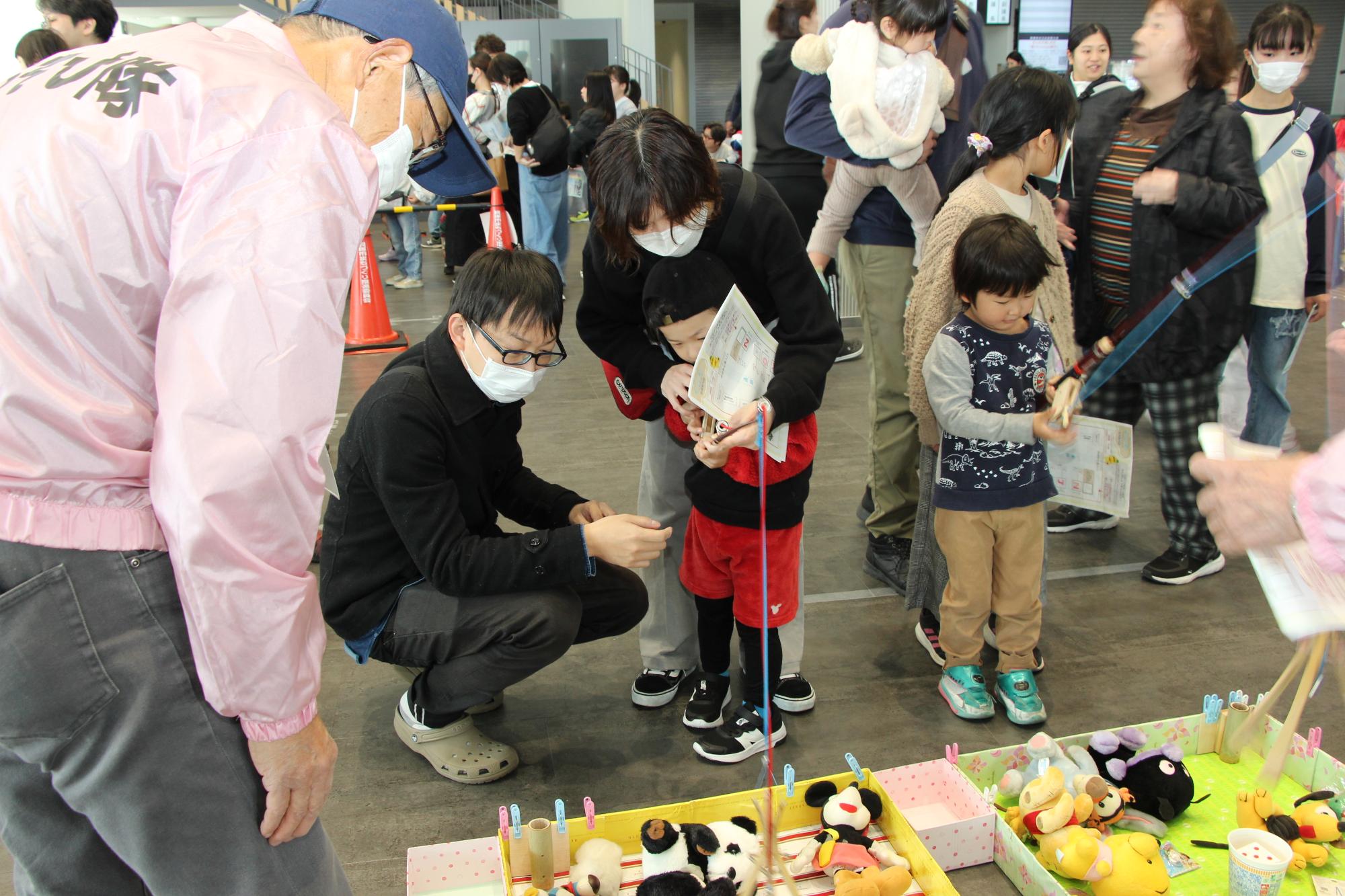 隊員が作ったクレーンゲームで遊んでいる様子