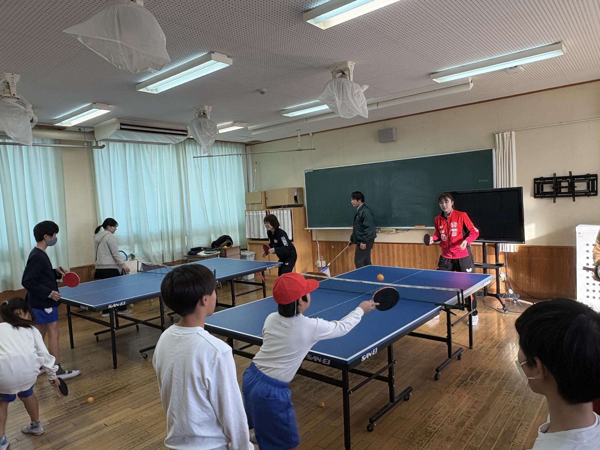 日本生命レッドエルフの選手と小学生がラリーをしている様子