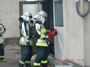 「消防突入訓練」消防士が鉄製扉を切断しています。